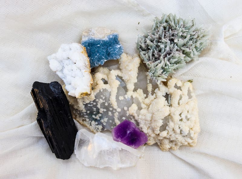 Diverse mineral specimens including amethyst and quartz on display.