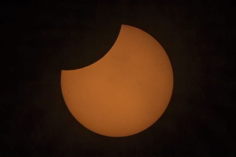 An impressive partial solar eclipse with the sun partially obscured by the moon.