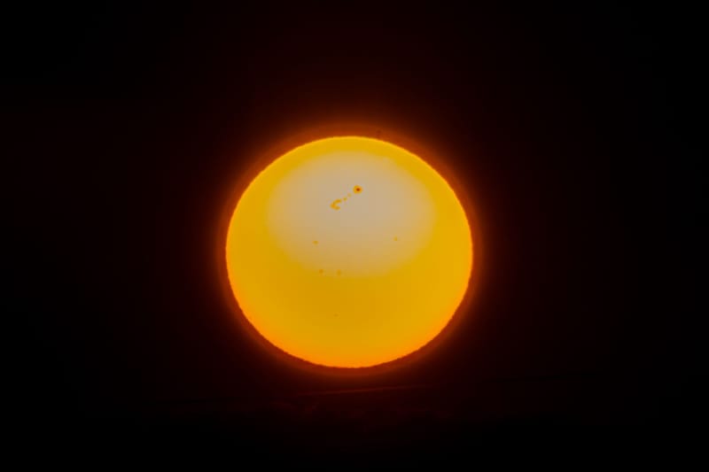 Close-up view of the sun showcasing solar flares and sunspots, captured in a cosmic setting.
