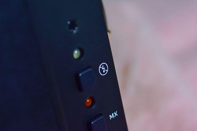Detailed close-up of buttons on a black electronic device with control indicators.