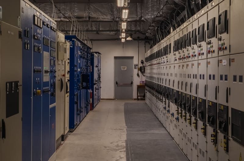 A sophisticated control room filled with electrical panels and equipment for industrial purposes.