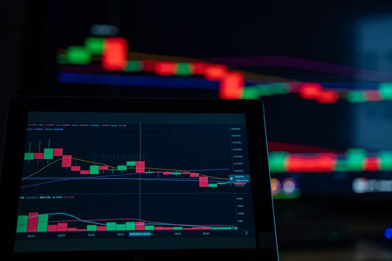 A close-up view of cryptocurrency trading charts showing a bearish trend in a digital market on a computer screen.