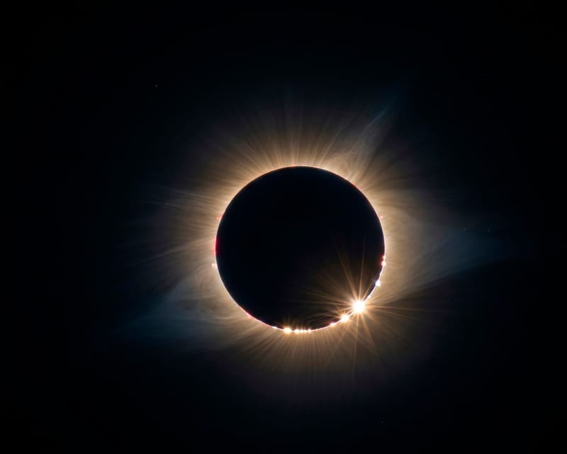 A breathtaking solar eclipse displaying the Baily's Beads effect and solar corona.