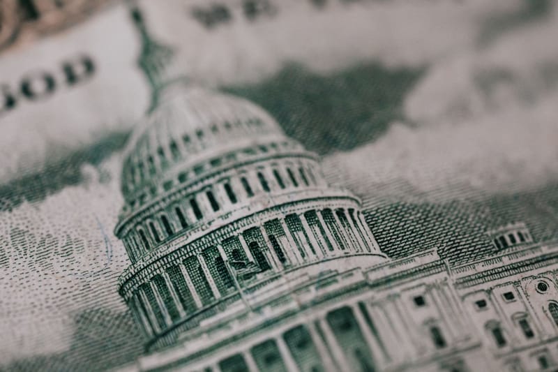 From above of photo of historic Capitol of USA Congress in neoclassical style with columns and dome represented on paper money
