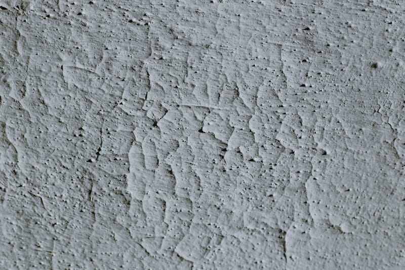 Detailed close-up of a textured concrete surface with visible cracks.