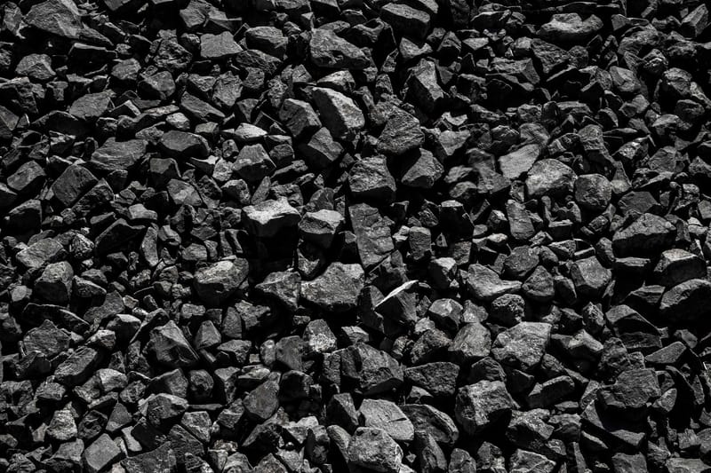 Black and white close-up of textured rocks, showcasing natural detail and contrast.