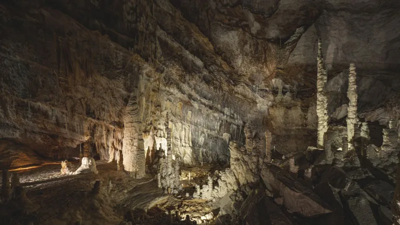 Explore a breathtaking underground cave showcasing stalactites and stalagmites.