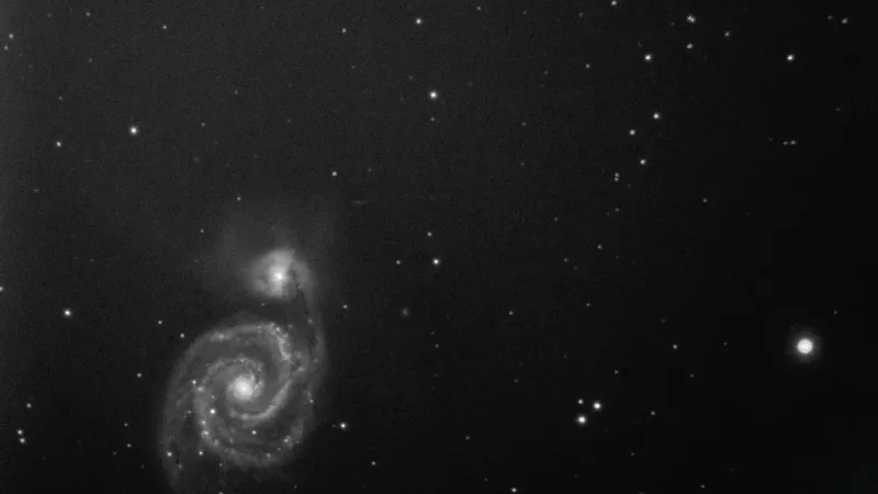 A captivating black and white image of a spiral galaxy in the expansive cosmos.