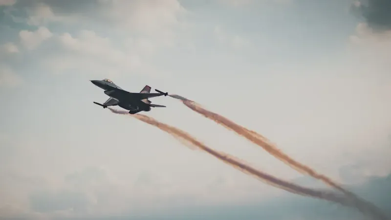 Dynamic capture of a military fighter jet soaring through a cloudy sky.