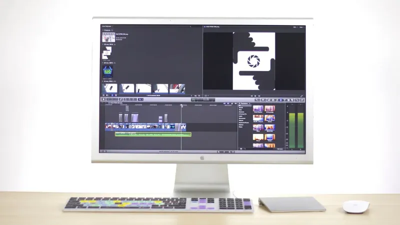 A sleek computer monitor displays video editing software in a modern workspace.