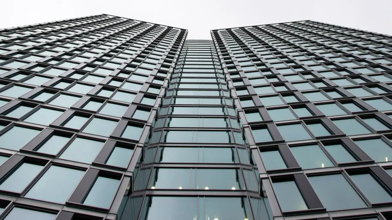 Low angle view of a modern office building with glass facade in Warsaw, Poland.
