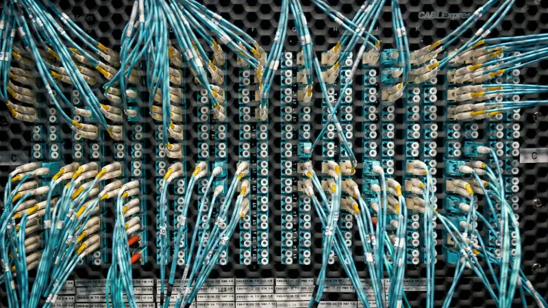 Overhead view of similar bright cables with plastic connectors in fiber optical switch