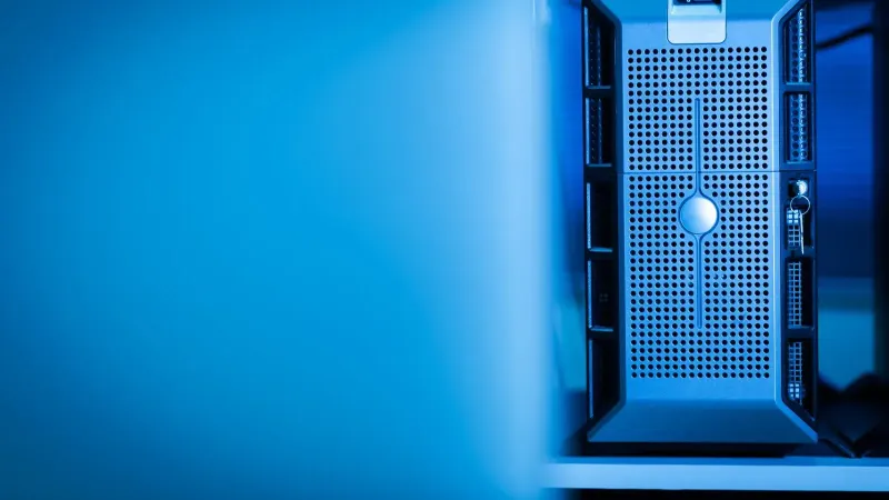 Close-up of a modern server unit in a blue-lit data center environment.