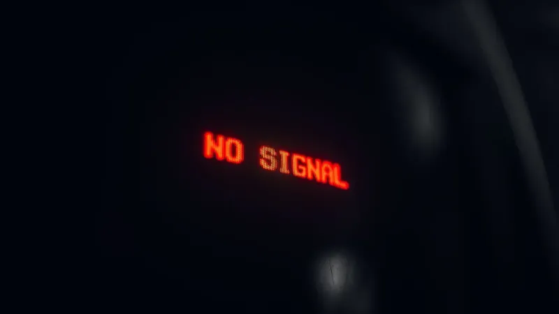A red LED display indicating 'No Signal' in a dark setting, conveying a tech warning.