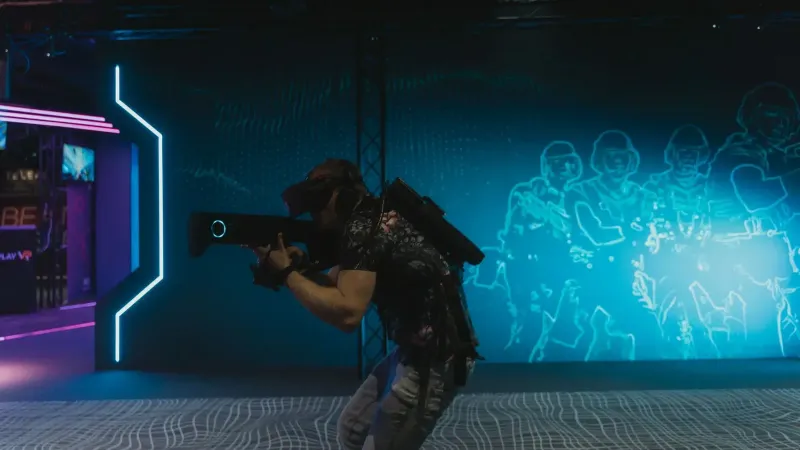 A man fully engaged in an immersive virtual reality gaming experience indoors.