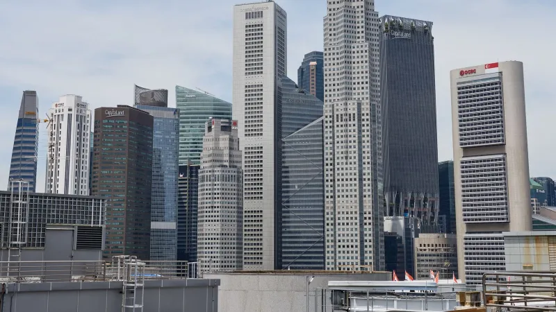 Stunning view of Singapore's modern skyline featuring iconic skyscrapers under a clear sky.
