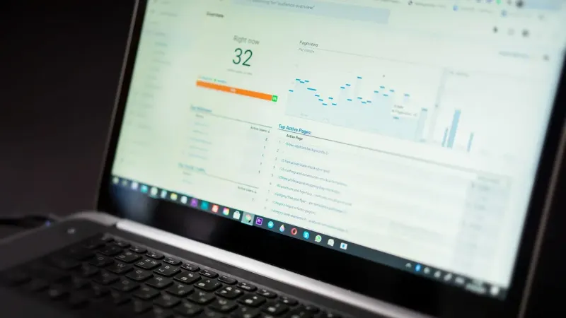 A laptop displaying an analytics dashboard with real-time data tracking and analysis tools.