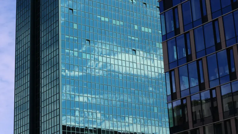 High-rise building with reflective glass windows showcasing a modern architectural style.