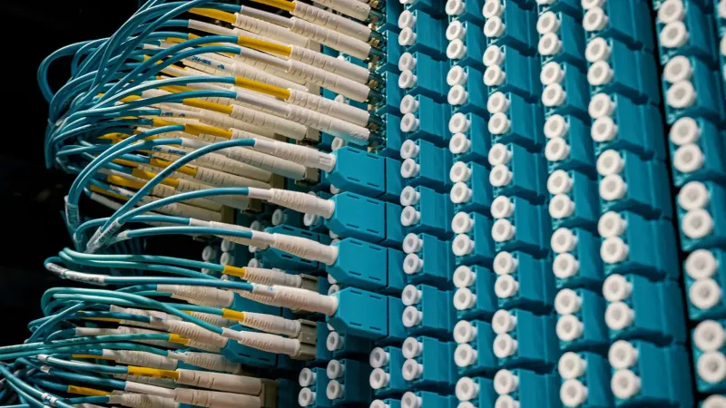 From below of fiber optic equipment with similar colorful rubber cables and round sockets