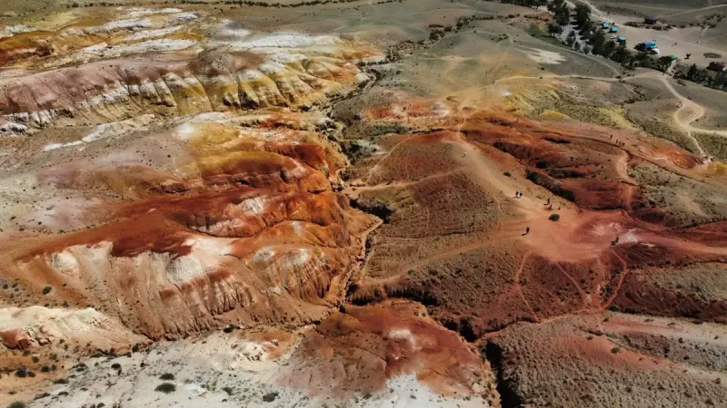 A stunning aerial view of colorful geological formations resembling a Martian landscape.