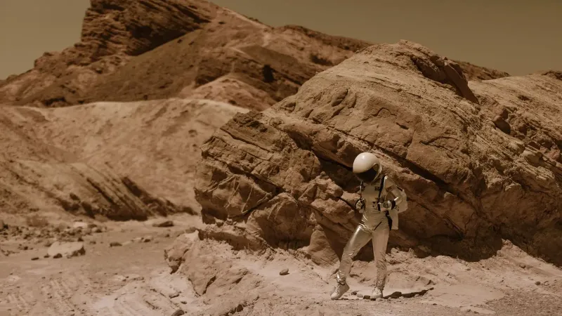 An astronaut in a space suit explores a barren desert landscape, resembling an alien planet.