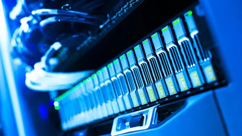 A detailed view of a blue lit computer server rack in a data center showcasing technology and hardware.