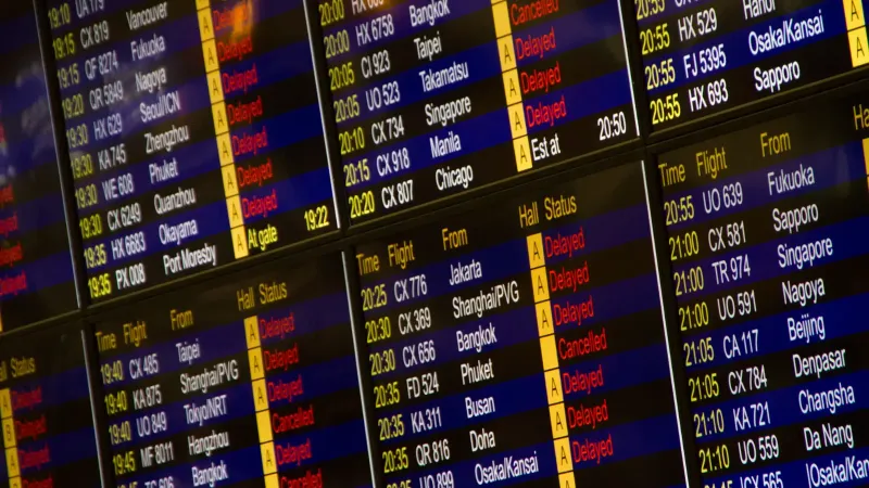 Close-up de la junta de información de vuelo digital que muestra las llegadas y salidas en un aeropuerto.
