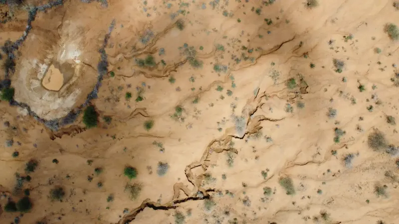 Aerial view capturing the arid, cracked terrain of Kimanjo, Laikipia County, Kenya.