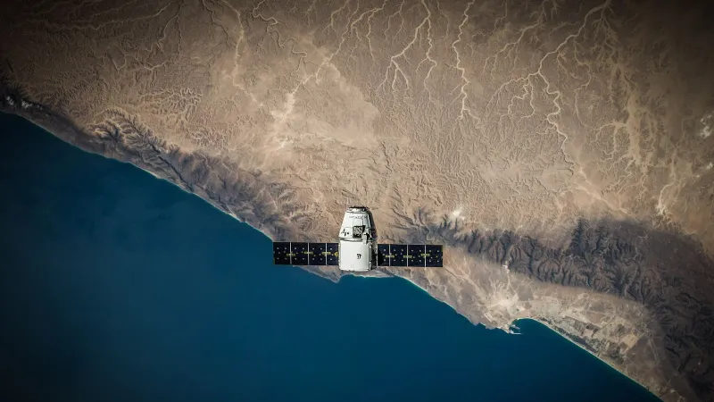 A satellite hovering above Earth's coastline, captured from space.