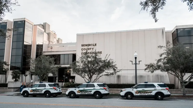 Sheriff vehicles parked in front of Seminole County Courthouse during the day.