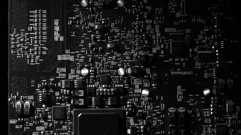 Detailed black and white photo of a circuit board showing intricate components, perfect for tech projects.