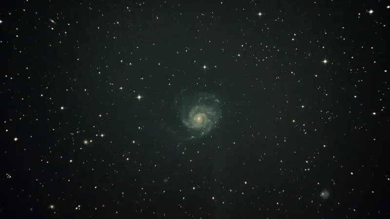 Deep space image featuring the mesmerizing Pinwheel Galaxy surrounded by stars.