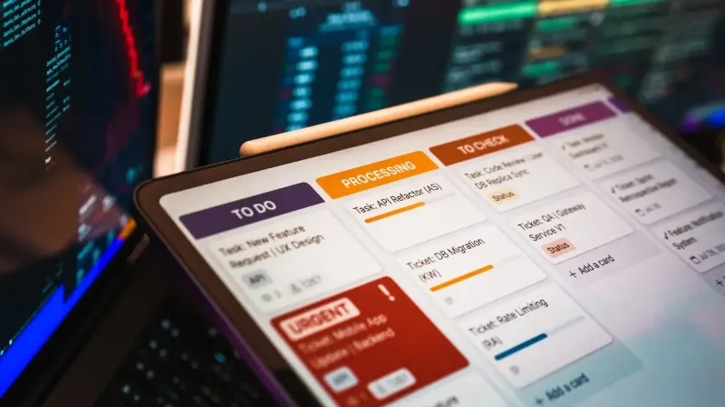 Kanban board displayed on screen with charts and data analysis in modern office setup.