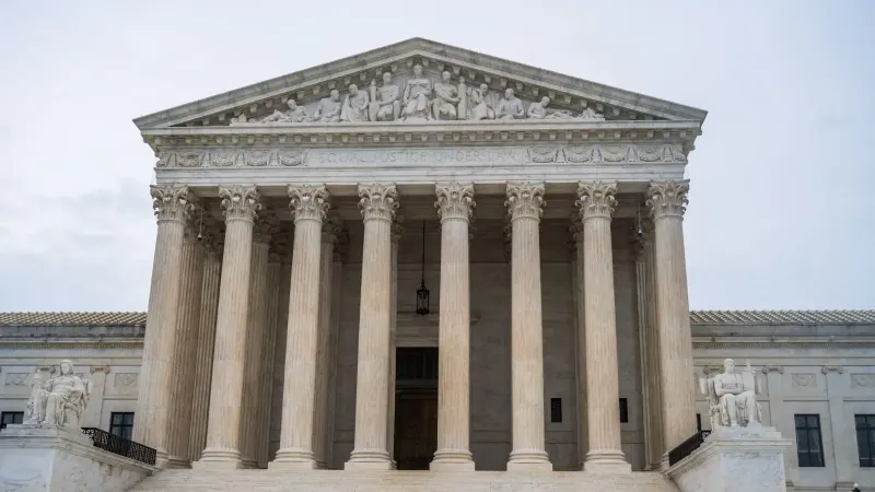 Front view of the iconic US Supreme Court building showcasing its grand columns and classic architecture.