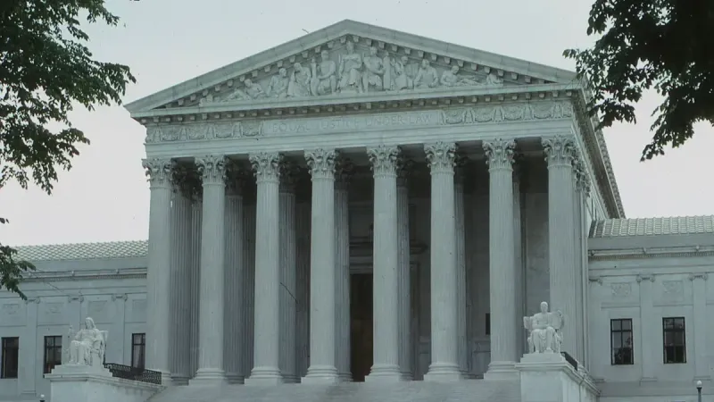 Front view of the iconic Supreme Court building with classical columns and majestic architecture.