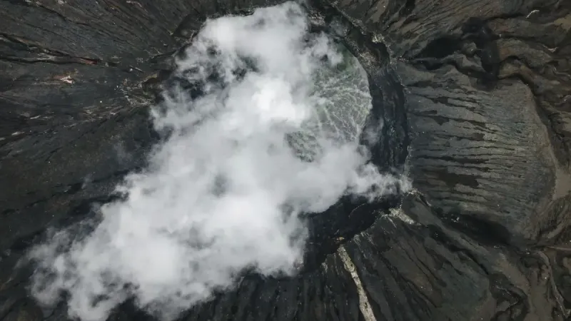 Aerial view of scenery with powerful rough soaring volcanic crater located in mountainous area