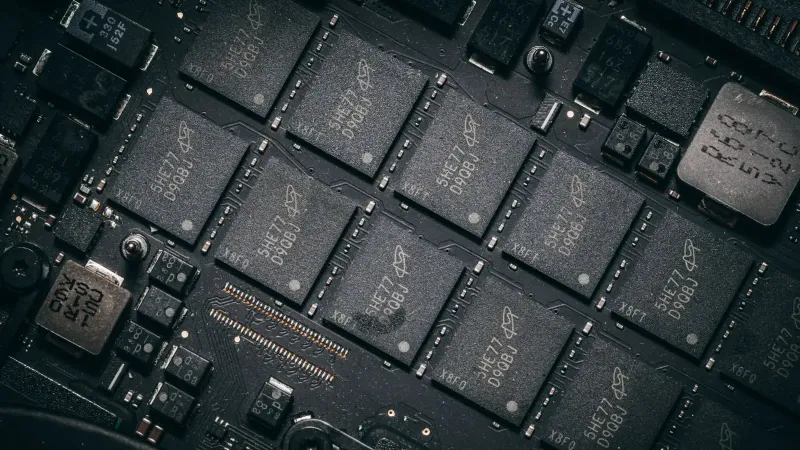 Detailed view of electronic circuit board components showcasing microchips and technology intricacies.