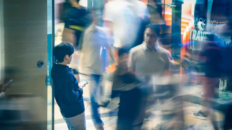 Blurred motion of people walking in Kowloon, Hong Kong, capturing urban life and activity.