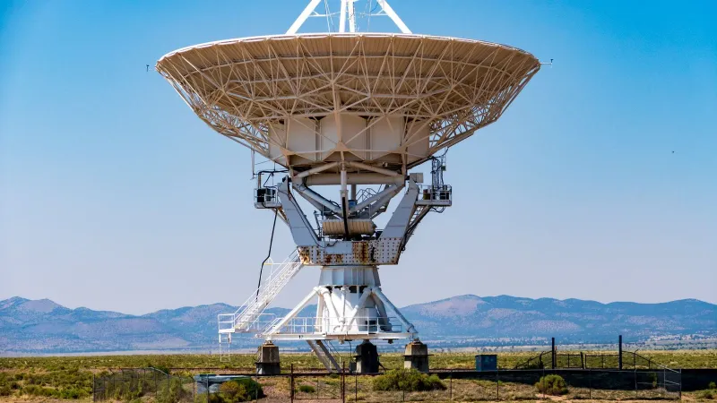 Close-up of a large radio telescope at the VLA, Socorro, New Mexico, against a clear blue sky.