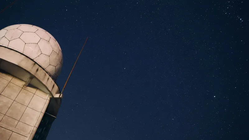 A stunning view of a starry night sky above an observatory dome, capturing the beauty of the cosmos.