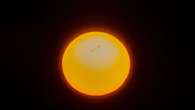 Close-up view of the sun showcasing solar flares and sunspots, captured in a cosmic setting.