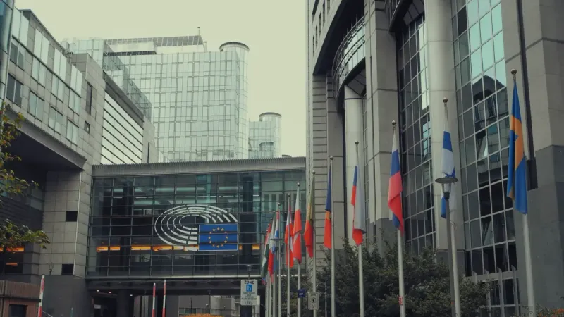 Exterior view of European Parliament with EU flags in Brussels