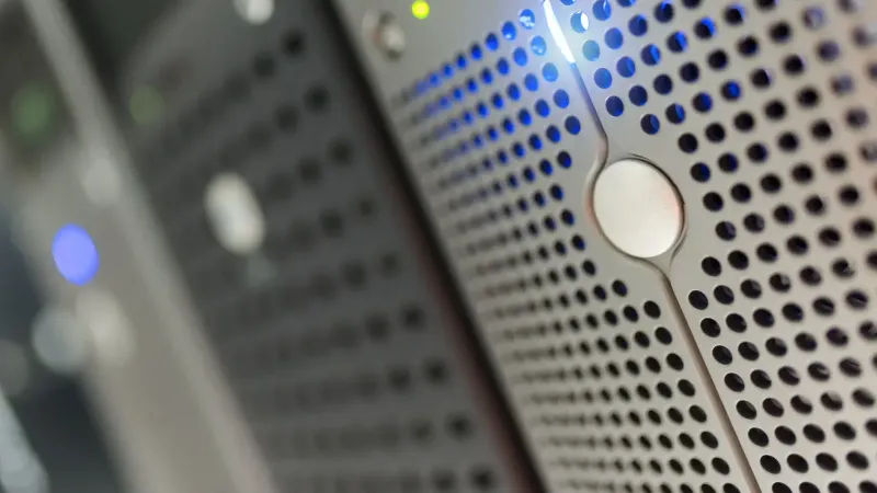 Focused detail of a modern server rack with blue LED indicators in a data center.