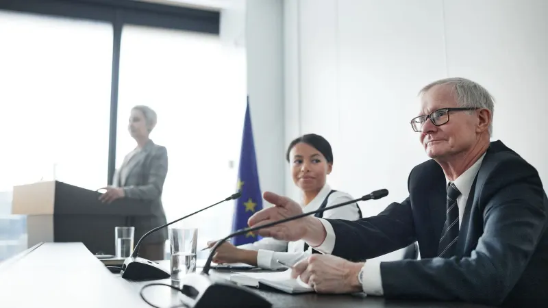 Panelists at an EU conference discussing law and diplomacy.