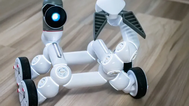 Close-up of a modern wheeled robot with a blurred background, indoors.