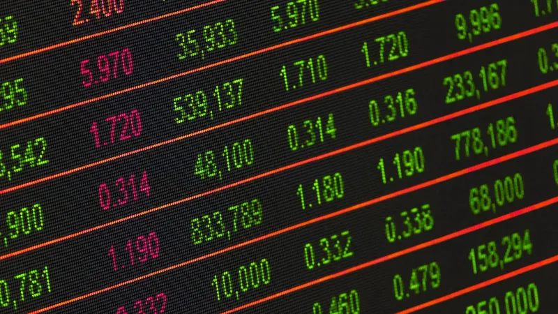 Close-up of a digital stock market data display showing colorful financial numbers and trends.