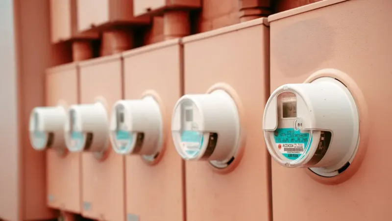 Close-up view of a row of industrial electricity meters for power monitoring and technology.