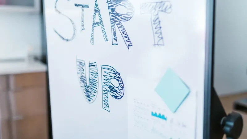 Creative startup concept handwritten on a whiteboard, symbolizing innovation in business.