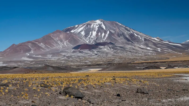 Stunning Andean mountain with snow caps under a clear blue sky.