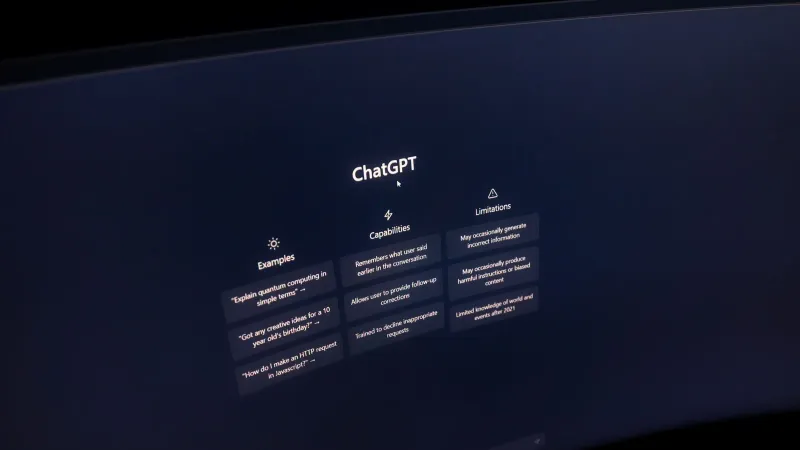 Close-up of a computer screen displaying ChatGPT interface in a dark setting.